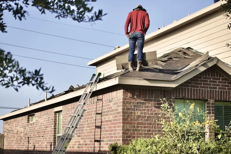 Professional roofer working on a residential roof in Newark Airport and Port Newark